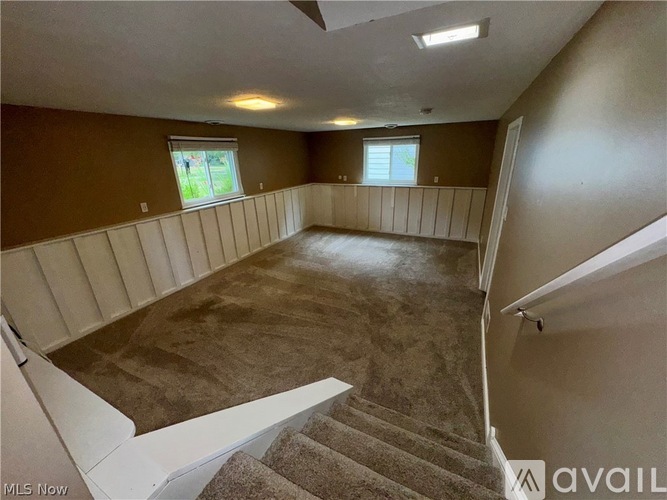 A room with a staircase leading to the upper floor.