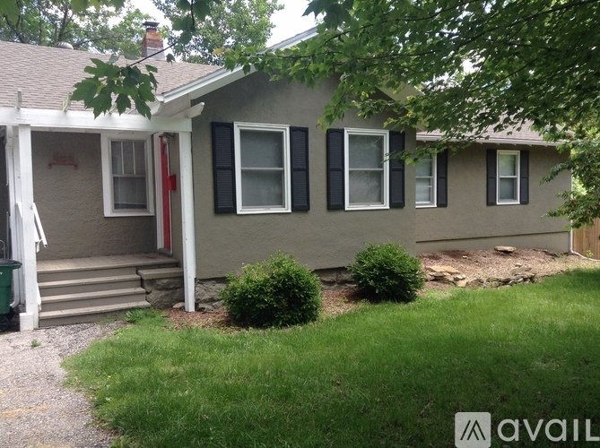 A house with a red door and a small front yard.