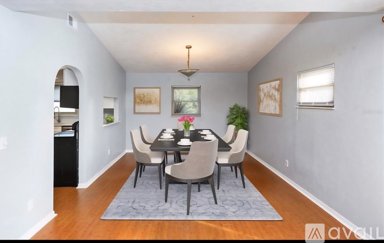A dining room with a table set for six.