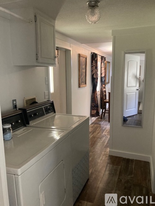 A kitchen with a white dishwasher and a white oven.