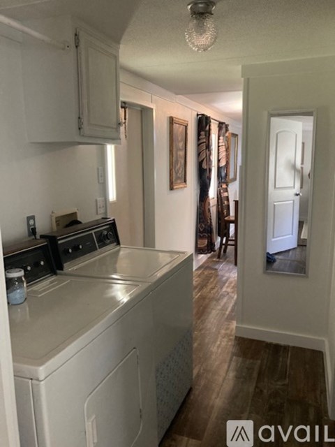 A kitchen with a white dishwasher and a white oven.