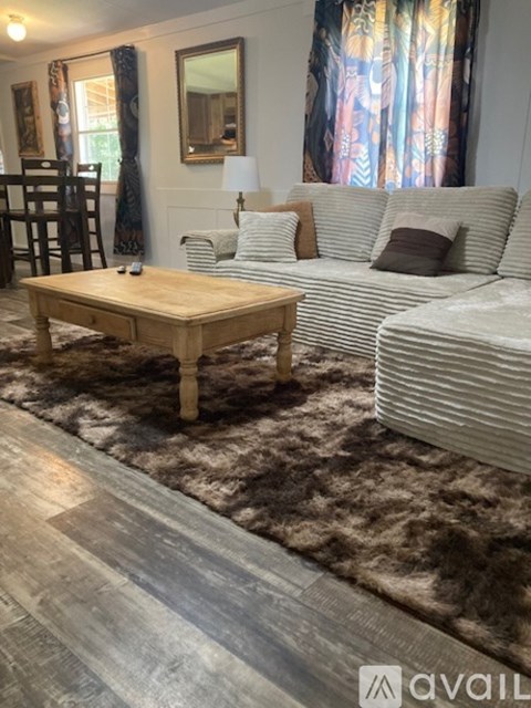 A living room with a wooden coffee table and a striped couch.