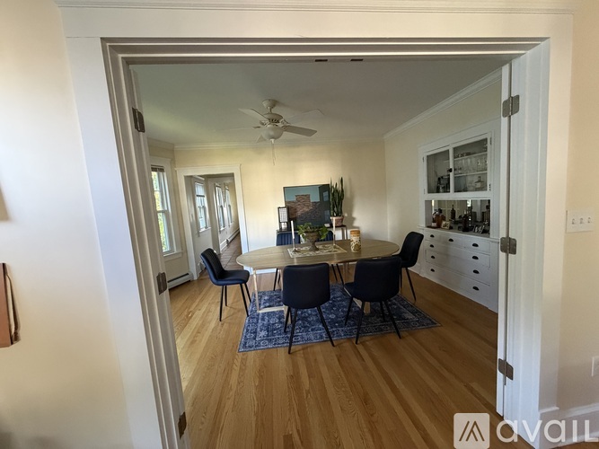 A dining room with a table set for four.