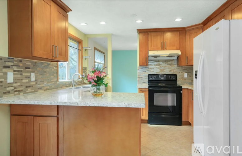 A kitchen with wooden cabinets and a white refrigerator.