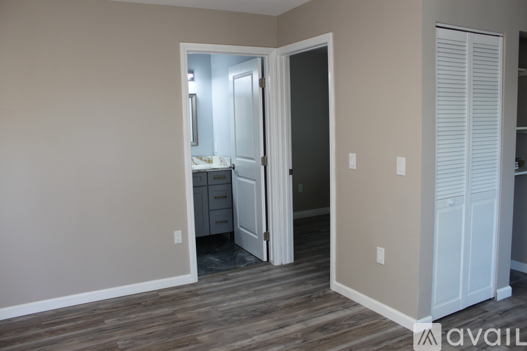 A room with a white door and a white closet.