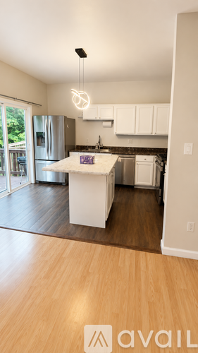 A kitchen with a white island in the middle of the room.