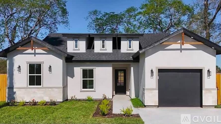 A modern house with a black roof and a white exterior is available for sale.