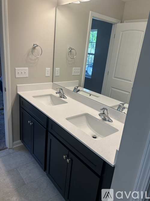 A bathroom with two sinks and a mirror.