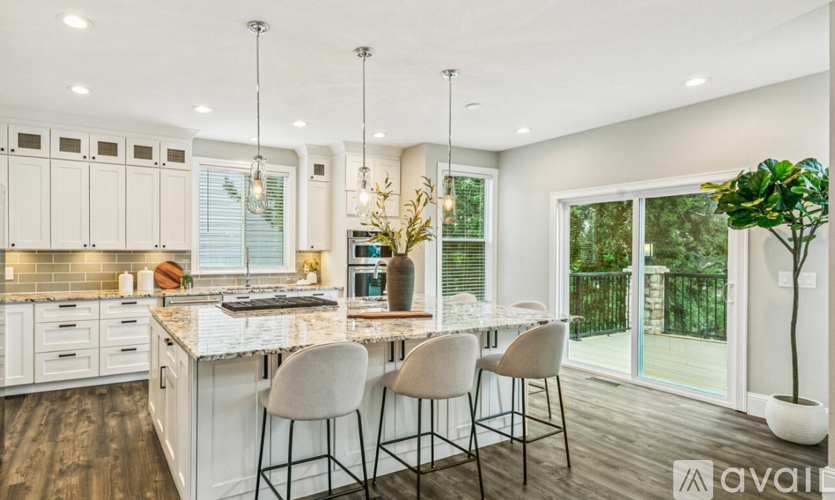 A modern kitchen with white cabinets and a large island.