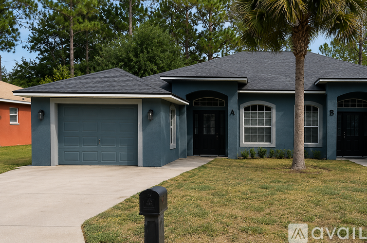 A house with a blue exterior and a grey roof with a palm tree in front.