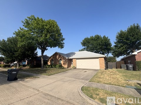 A residential area with a house, driveway, and trees.