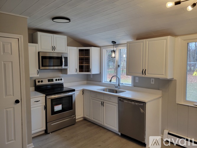 A kitchen with white cabinets and stainless steel appliances.