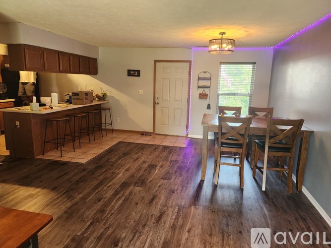 A kitchen with a dining table and chairs.