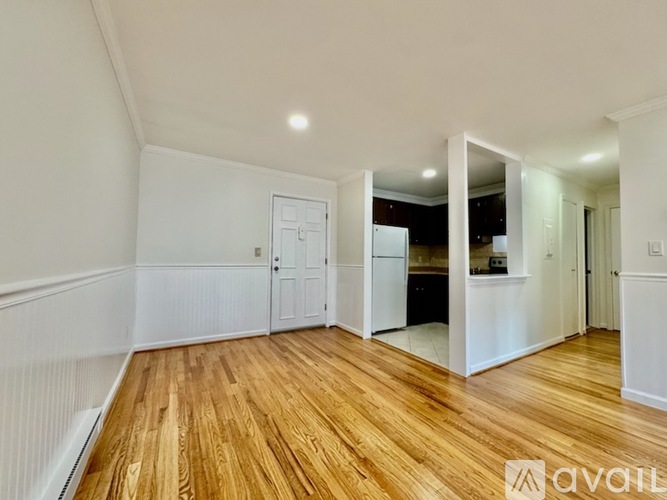 A room with wooden floors and white walls.