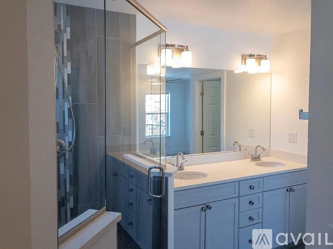A bathroom with a blue cabinet and a white countertop.