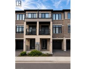 A modern apartment building with a balcony on the second floor.