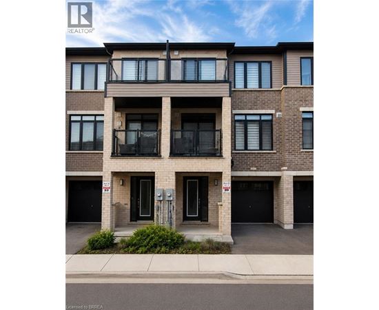 A modern apartment building with a balcony on the second floor.