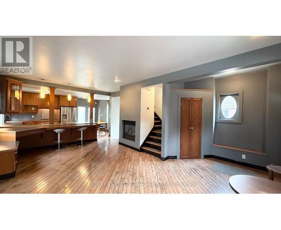A spacious open floor plan with a kitchen, dining area, and living room.