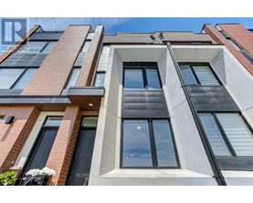 A modern building with a mix of brick and white facade.