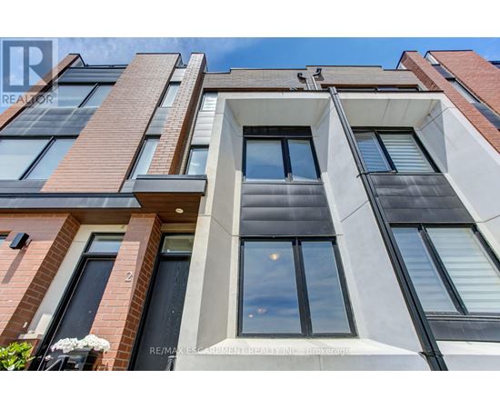 A modern building with a mix of brick and white facade.
