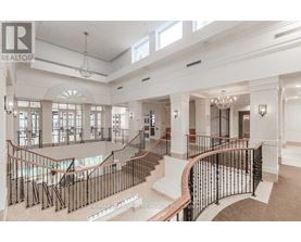 A large, well-lit, and spacious interior of a building with a curved staircase.