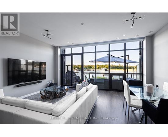 A modern living room with a large white sofa and a glass table.