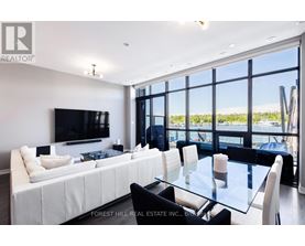 A modern living room with a large white sofa and a glass table.