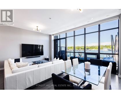A modern living room with a large white sofa and a glass table.