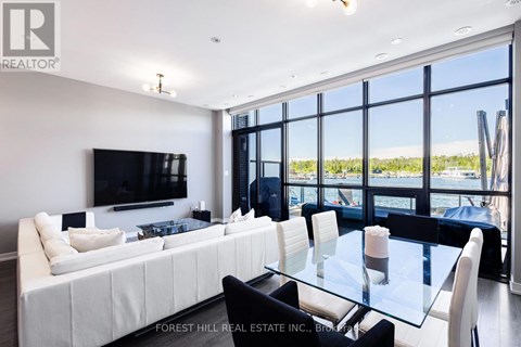 A modern living room with a large white sofa and a glass table.