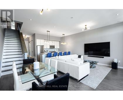 A modern living room with a glass table and white furniture.