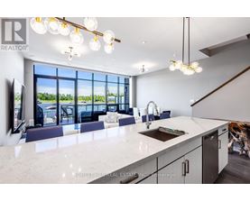 A modern kitchen with a large island and a view of the outdoors.