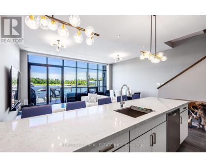 A modern kitchen with a large island and a view of the outdoors.