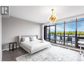 A bedroom with a large bed and a view of the outside.