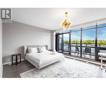 A bedroom with a large bed and a view of the outside.