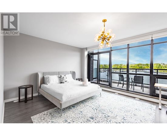 A bedroom with a large bed and a view of the outside.