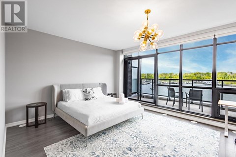 A bedroom with a large bed and a view of the outside.