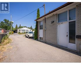 A residential area with a house and a car parked in front.