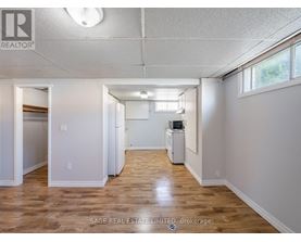 A spacious room with wood flooring and a white ceiling.