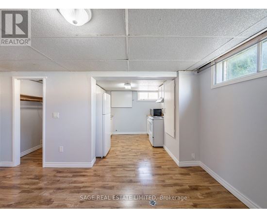 A spacious room with wood flooring and a white ceiling.