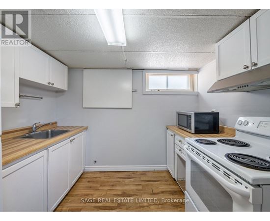 A small kitchen with white cabinets and a white stove top oven.