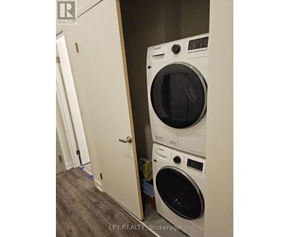 A white dryer and washer are stacked on top of each other.