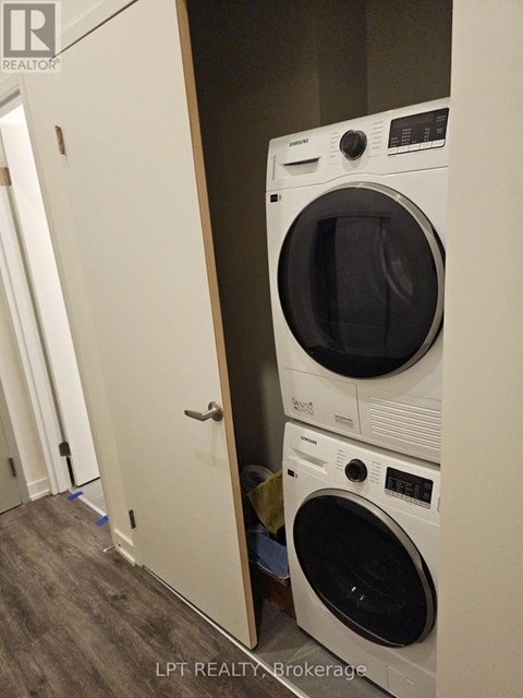 A white dryer and washer are stacked on top of each other.