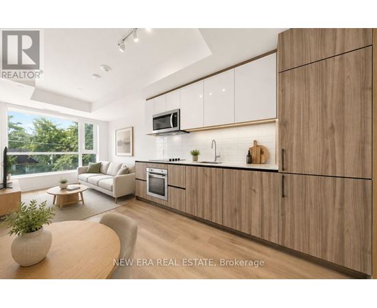 A modern kitchen with wooden cabinets and a large window.