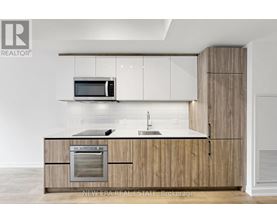 A modern kitchen with wooden cabinets and a white countertop.