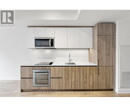A modern kitchen with wooden cabinets and a white countertop.