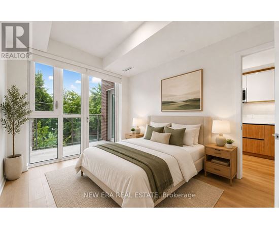 A bedroom with a large bed, a painting on the wall, and a potted plant.