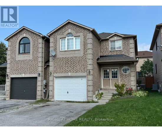 A brick house with a garage door is for sale.