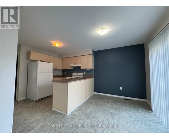 A kitchen area with a refrigerator, microwave, and oven.