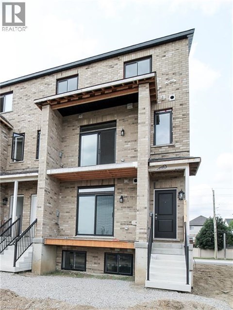A modern house with a balcony and a black door.