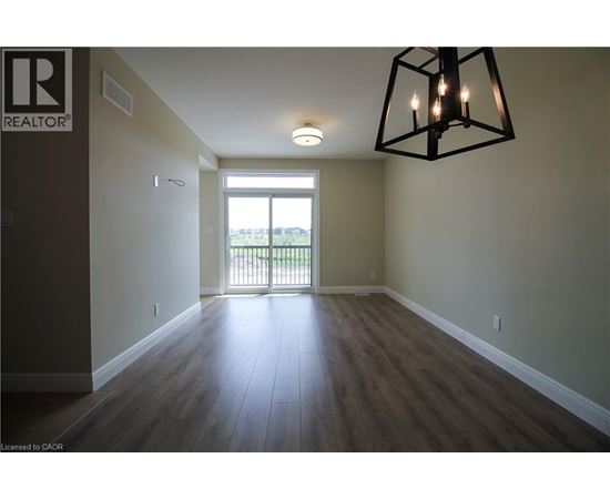A room with a wooden floor and a large window.